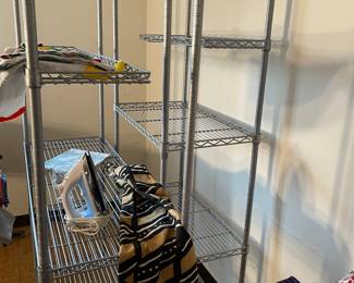 Two metal shelves, African cloth, iron