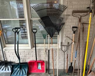 Assorted Garden Tools including Snow Shovels, Leaf Rakes, and Hoes