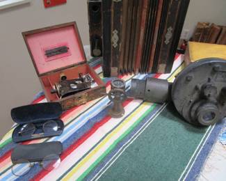 Antique glasses, antique child's sewing machine in box, Navy 1940s telescope, and small vintage compass