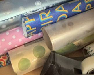 Assorted Rolls of Wrapping Paper and Tape Dispenser
