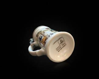 Collection of Three German Beer Steins: Relief Ceramic, Pewter-Lidded Embossed, and Cartoon-Style Ceramic