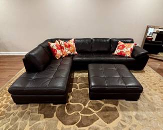 Black leather sectional with matching ottoman.  Two piece sectional
