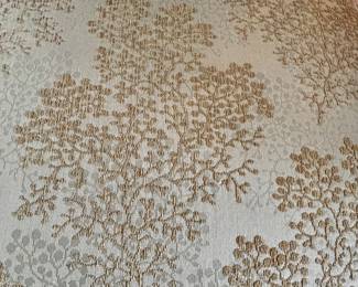 Details of armless chair fabric fades from grey to warm shades