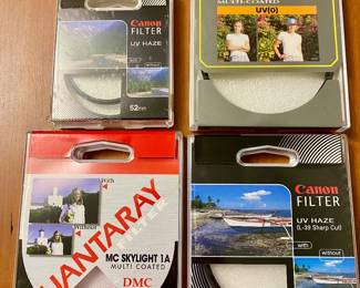 Collection of camera lens filters in original packaging  from Canon and Quantaray
