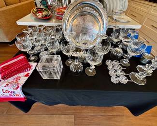Crystal stemware, salt cellars and silverplate platters