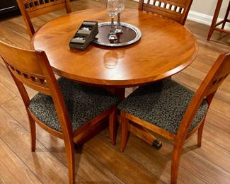 42" round light cherry dining table with four chairs