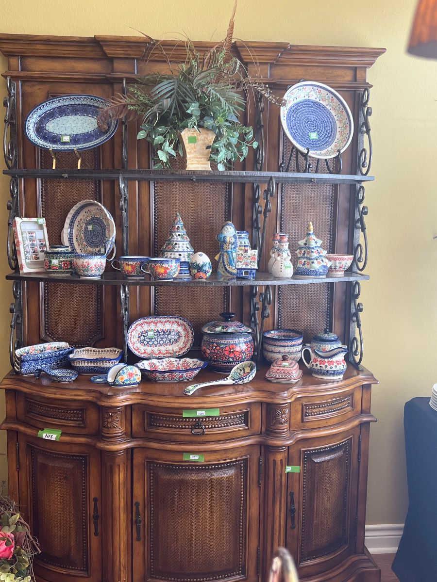 30+ Pieces of Handpainted Unikat Polish Pottery from Boleslawiec, Poland. Collection contains several designs and includes: Soup Terrine, Ladle, Soup Mugs, Spoon Rest, Gravy Boat, Butter Dish, Serving Platters and Bowls. Numerous Christmas items include: Christmas Tree Luminaries, Snowmen, and Santa. (Baker's Rack NFS)