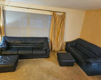 2 matching dark blue leather sofas with matching ottomans $300 each set