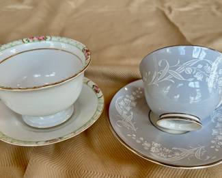 On the left, Nippon hand painted cup and saucer. On the right, Royal Doulton "Valley Field" cup and saucer.