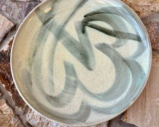 Brushwork on stoneware plate.