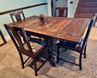Vintage dining table with barley twist legs and four chairs.