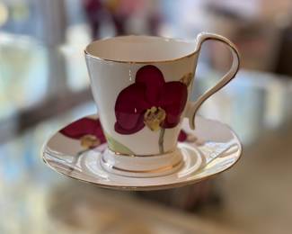 Purple orchid cup and saucer by Naremoa Studio.  Two sets in original box.