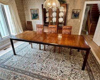Davis Furniture dining table with six chairs.  Table extends to 118' with the three leaves.  Matching china cabinet in background.  "Tree of Life" area rug.