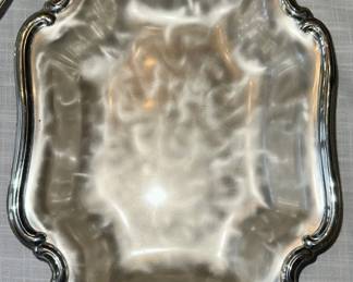 Silver-plated serving tray with brushed swirl design.