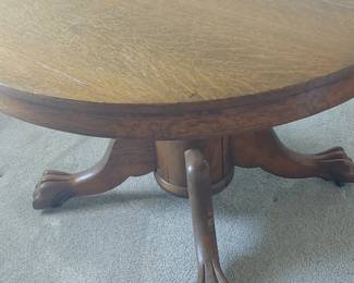 Vintage 48 inch round tiger oak dining table with claw feet and casters