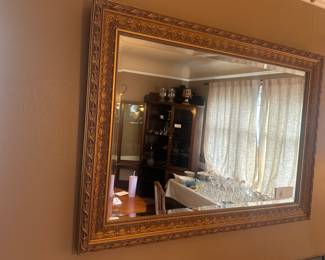 Gold framed beveled mirror. Available for sale in person.