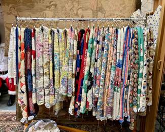 Rack of vintage and antique quilts