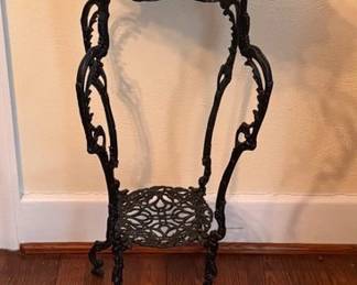 Cast iron plant stand with a marble top