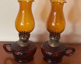Two vintage miniature amber glass oil lamps