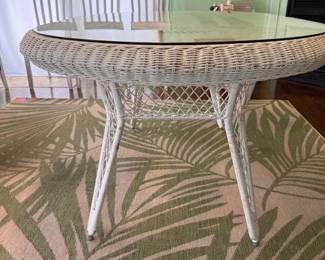 Glass top wicker table and Balta area rug
