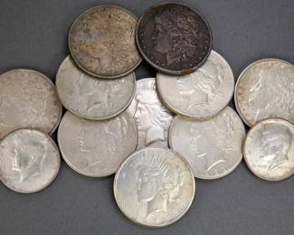 US Silver Peace Dollars and Morgan Dollars. Two Kennedy Half Dollars.