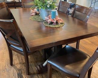 Rustic farmhouse style table.  Leafs insert at the end, includes 6 chairs and additional fabric for seats. 