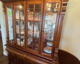 Beautiful china cabinet. This piece would also be great to upcycle! It is 2 pieces. The bottom is perfect for coffee bar, tv console or buffet. The top can be modified - remove the ornate top, mount to wall as display for coffee bar, dishes or curio. Lighted on top. Things to ponder!!