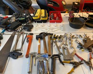 table full of hand tools...wrenches, hammers, 
