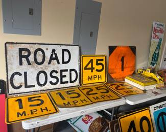 Vintage road signs including speed limits and "road closed"
