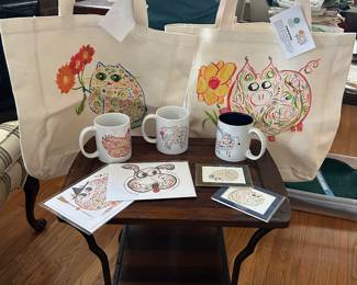 New totes, mugs, tumblers, minis, and greeting cards with this artist’s work.