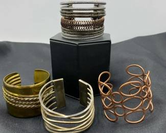 Four Cuff Bracelets In Various Metals
