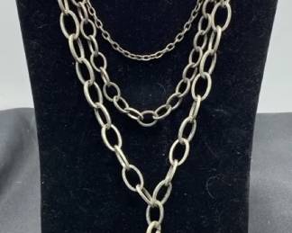 Silver Toned Necklace With A Criscross Pendant  Dangle Earrings