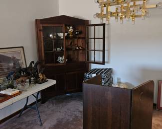 Step back view of items in the dining room (Antiques corner cabinet, Duncan Phyfe table on its side, mis items