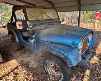 {possibly a 1981} Jeep CJ-5 has been stored outdoors under this metal cover. No title. Taking Bids