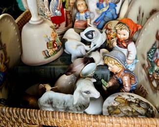 Basket of German themed items including Hummel figurines Hummel collectible plates, Bell, Beer Stein, Siamese cat, sleeping cat, porcelain pigs and more