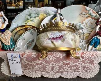 Basket of assorted vintage porcelain figurines, plates, and decorative items