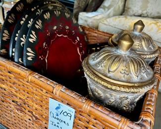 Basket of wooden chargers and decorative lidded jars