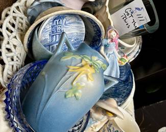 “Got the blues” lot featuring pressed blue glassware, blue patterned China, Roseville Pottery vase, collectible figurines, antique doilies and table linens