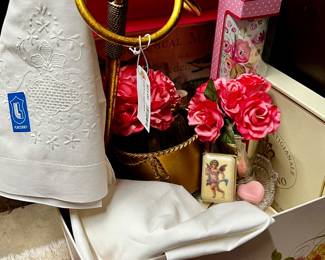 Powder room decor  including handmade soaps, linens, towel, holder, silk flowers, and vanity tray