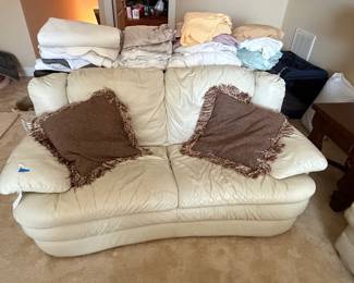 Cream Leather Sofa with Decorative Pillows