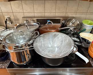 Assorted Stainless Steel Cookware with Ceramic Bowls and Plates