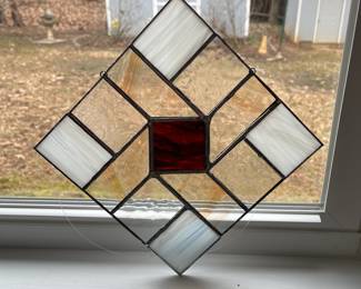 D6 - $25. Stained Glass. Measures 8" square. Hangs diagonally. White, Clear & Amber/Brown Center. 