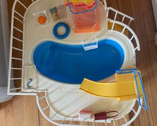 D137 - $40. Vintage 1980s Barbie Dream Swimming Pool & Accessories. The pool itself has a significant crack. 