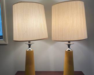 D67 - $30 PAIR of yellow leather wrapped lamps with Chrome accepts.  Leather has scratches/ marks, dents. Shows heavy use. Shades are ok. Measures 30.5" tall. 