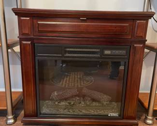 D59 - $30. Duraflame Electric Fireplace. NOTE - Front power button doesn't work but the remote does work! Measures 31" wide x 11.5" deep x 30" tall. 