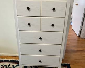 D52 - $50. White Chest of Drawers. Pressed wood - all drawers slide easily. Measures 28" wide x 15.5" deep x 46" tall. 