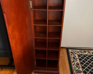 D45 - $50. Bombay Co. CD Cabinet. Doors on 2 sides to hide CDs. Shelves are not adjustable. Measures 12.5" x 13" x 37.5" tall. 
