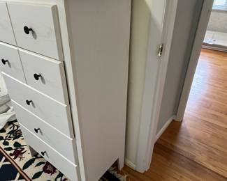 D52 - $50. White Chest of Drawers. Pressed wood - all drawers slide easily. Measures 28" wide x 15.5" deep x 46" tall. 