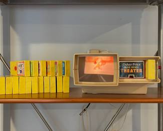 D74 - $50. Fisher Price Movie Viewer Theater. Needs adjustments but it does work! Powers on, rotates, movie is visible. Includes 18 cartridges. 