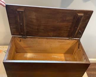 D65 - $45. *Small* Antique Wooden Chest on Wheels. Measures 25" wide x 11" deep x 11.5" tall. Top has some damage to the finish but it is solid wood. 